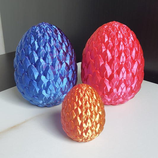 Shiny 3D printed fantasy dragon egg models in three sizes and colors