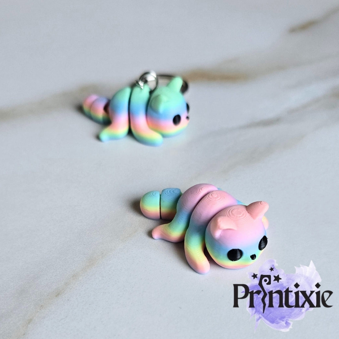 Rainbow 3D printed tiny cat keychain and flexible toy, made by Printixie
