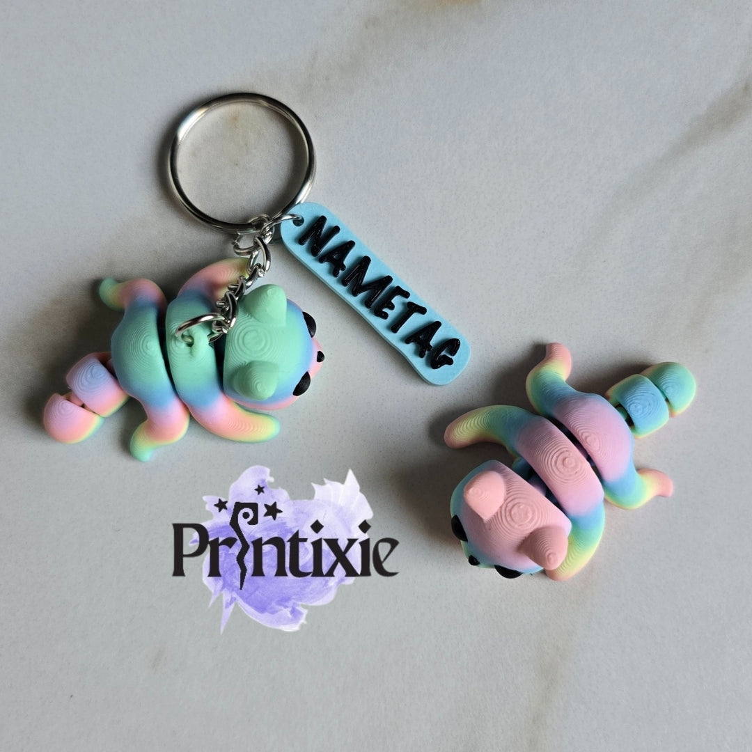 Rainbow 3D printed tiny cat keychain with name tag and flexible toy, made by Printixie
