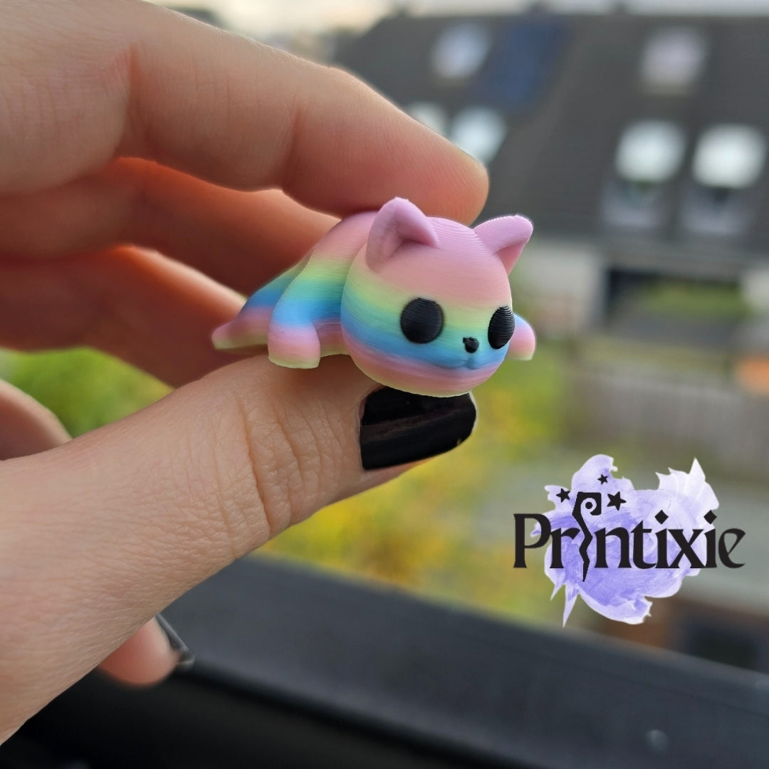 Rainbow 3D printed tiny cat keychain and flexible toy, made by Printixie