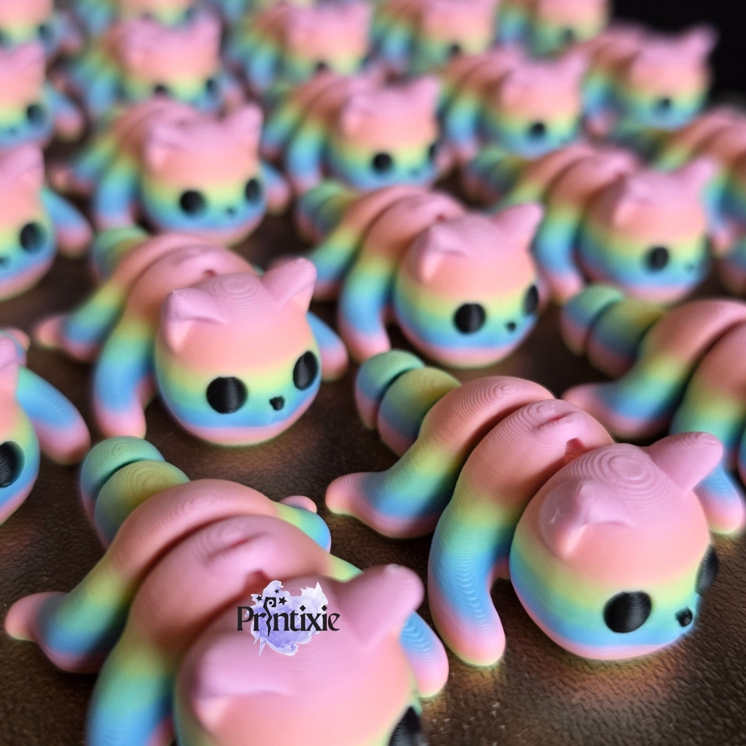 Rainbow 3D printed tiny cat keychain and flexible toy, made by Printixie