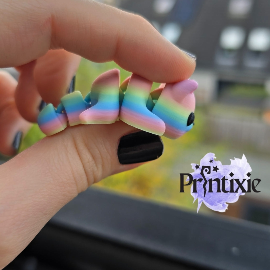 Rainbow 3D printed tiny cat keychain and flexible toy, made by Printixie