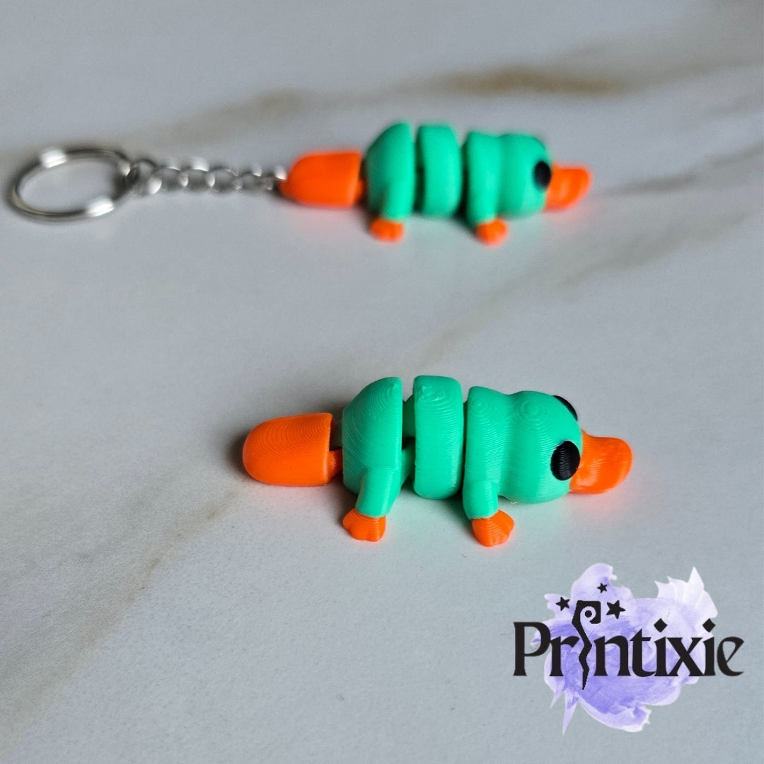 Tiny Platypus – a cute and flexible 3D printed toy and keychain. Made by Printixie