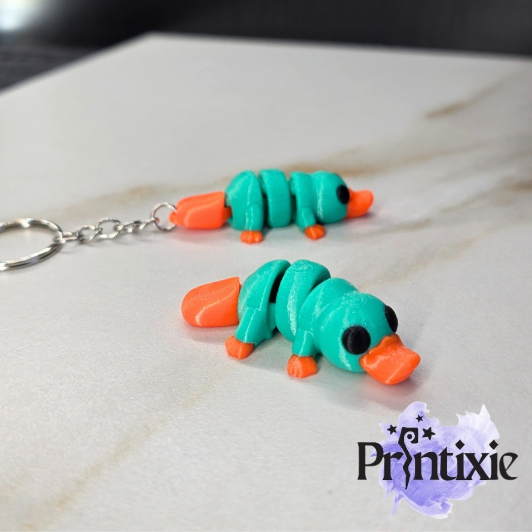 Tiny Platypus – a cute and flexible 3D printed toy and keychain. Made by Printixie