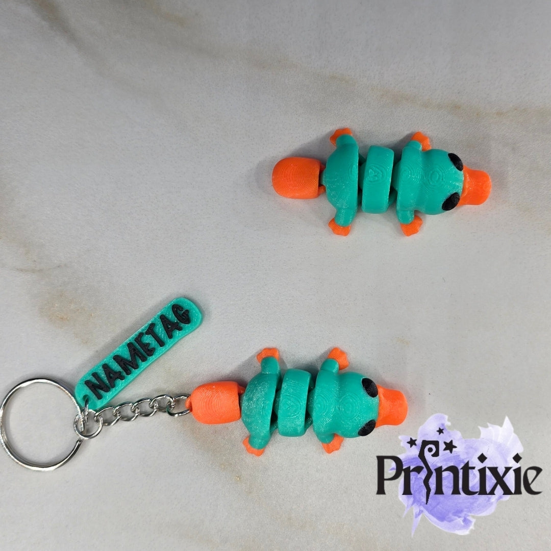 Tiny Platypus – a cute and flexible 3D printed toy and keychain. Made by Printixie