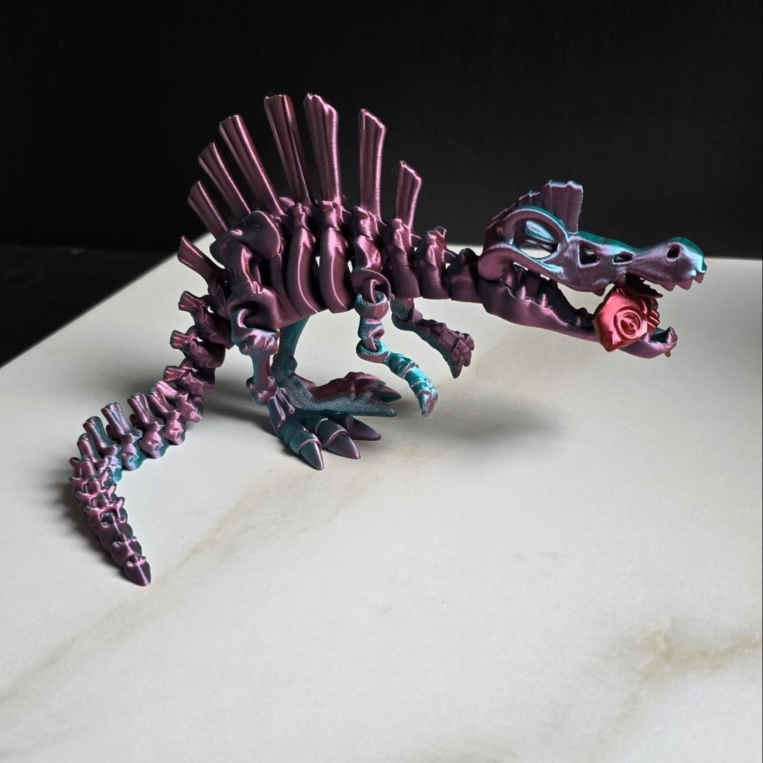 A 3D-printed flexible Spinosaurus dinosaur toy in multicolor, poseable with a fish accessory.